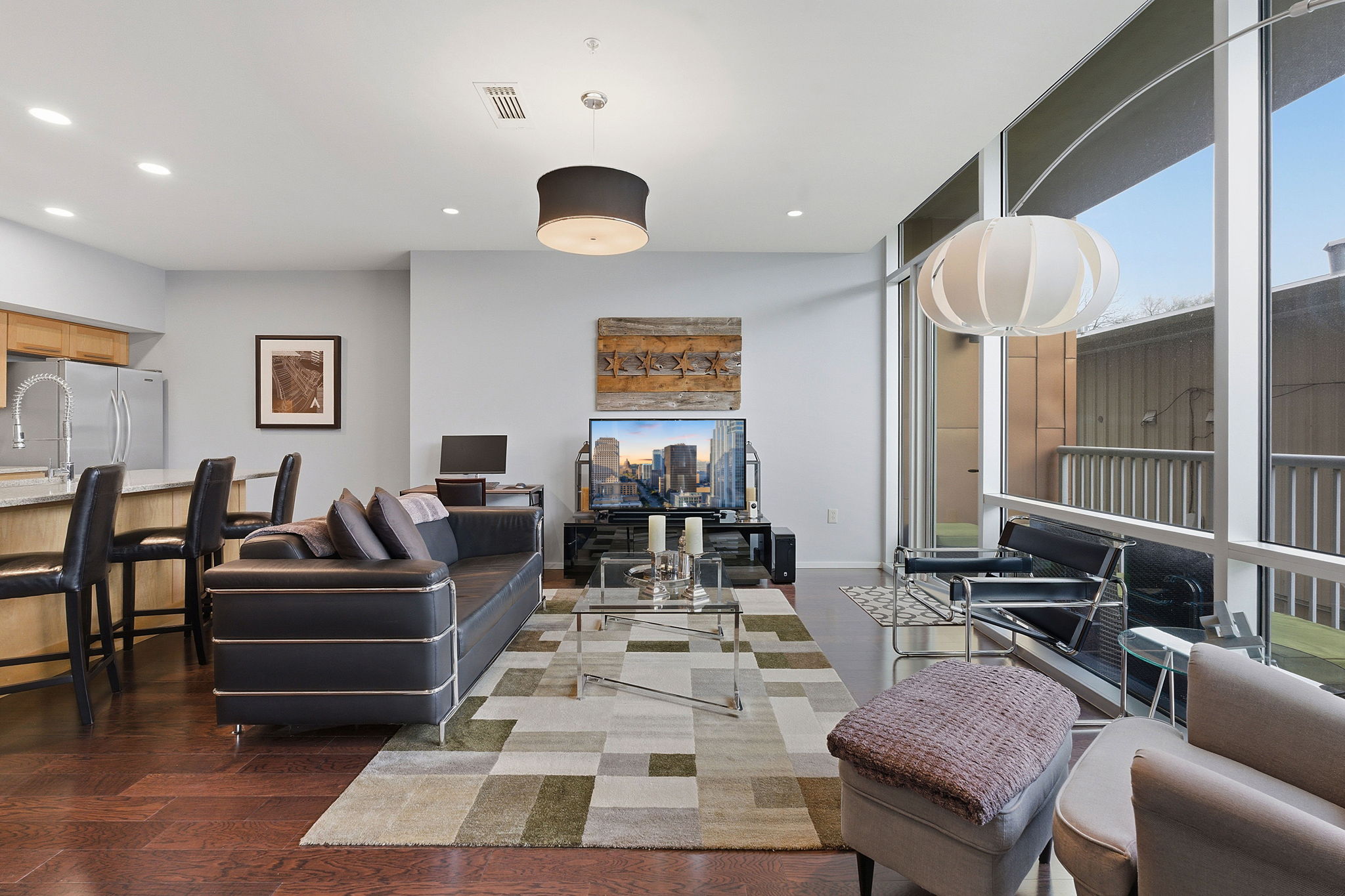1600 Barton Springs Road, Unit 1106 Austin, TX 78704 - Photo 2 of 39 a living room with furniture and wooden floor