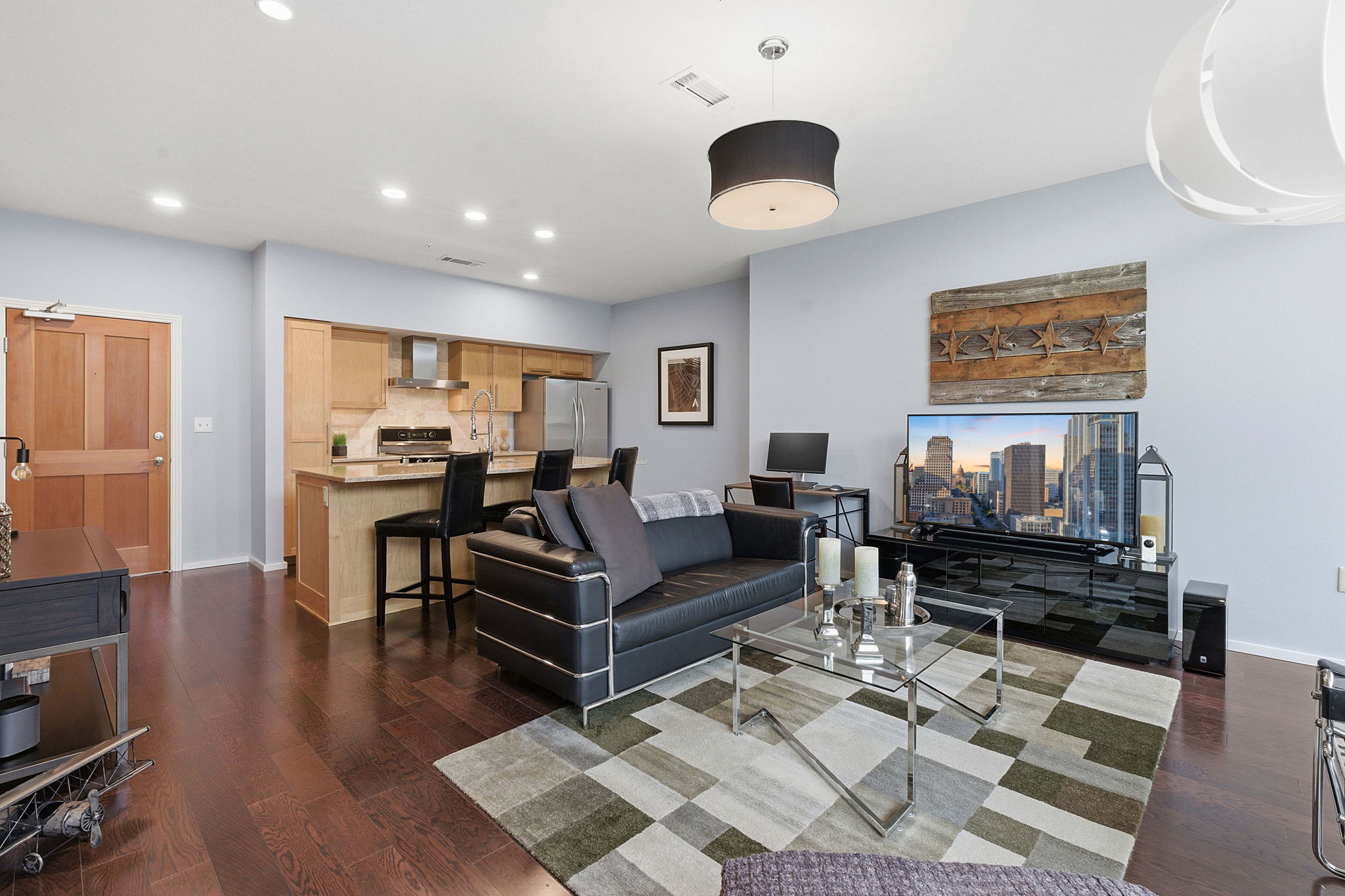 1600 Barton Springs Road, Unit 1106 Austin, TX 78704 - Photo 3 of 39 a living room with furniture and a flat screen tv