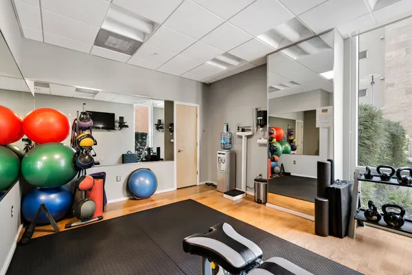 a room with furniture and gym equipment