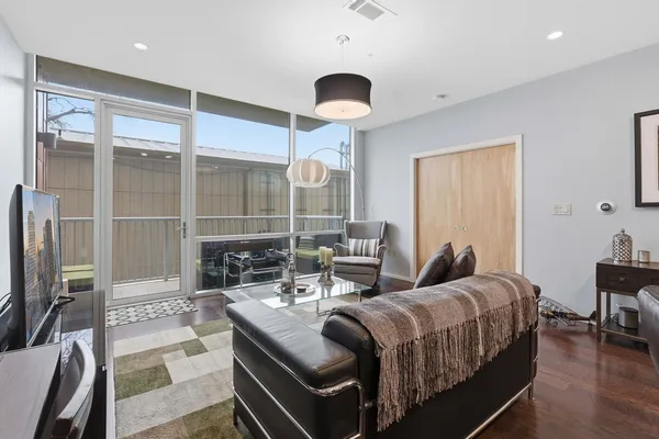 a bedroom with bed and a large window