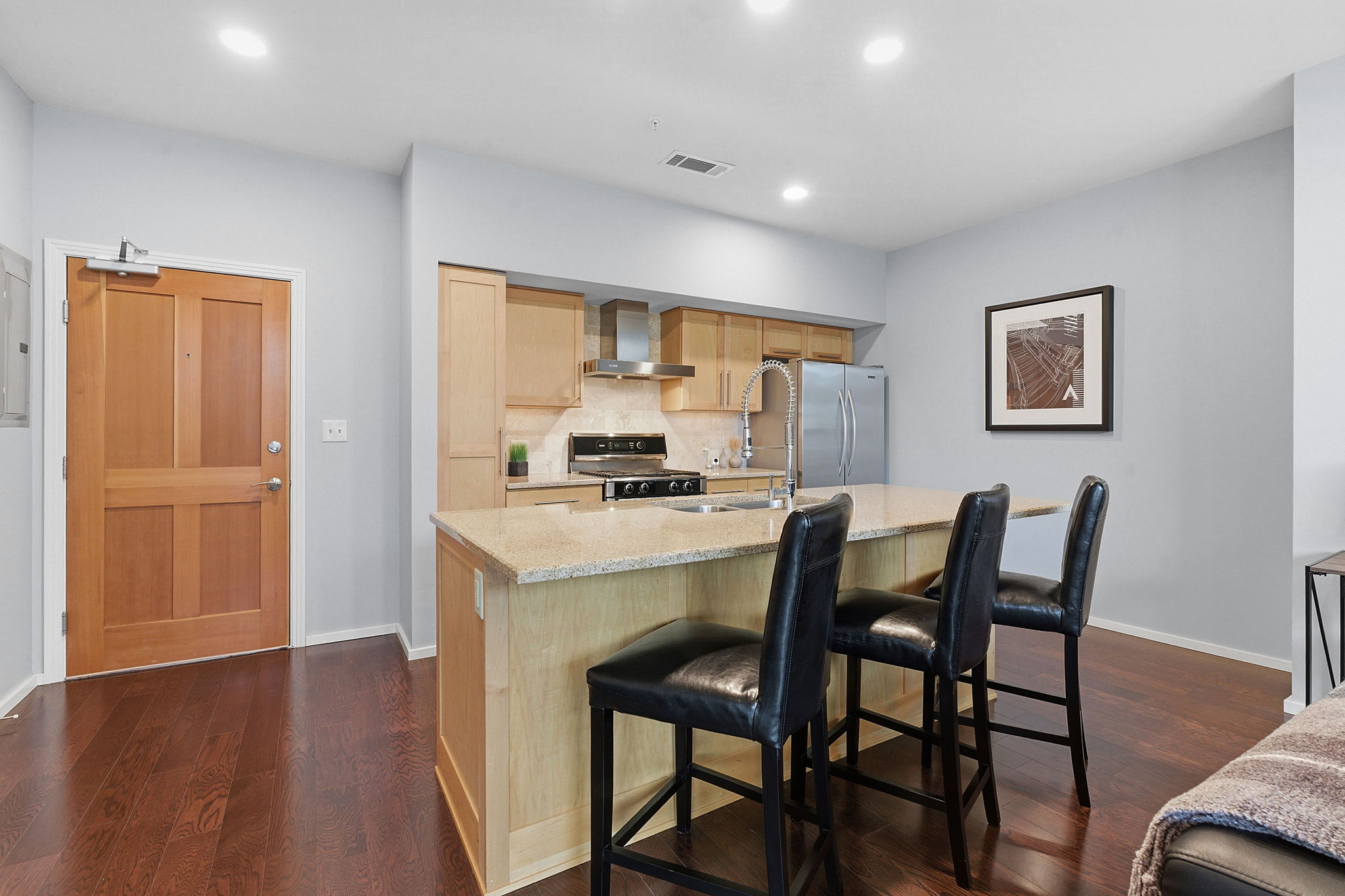 1600 Barton Springs Road, Unit 1106 Austin, TX 78704 - Photo 7 of 39 a kitchen with a table chairs refrigerator and cabinets