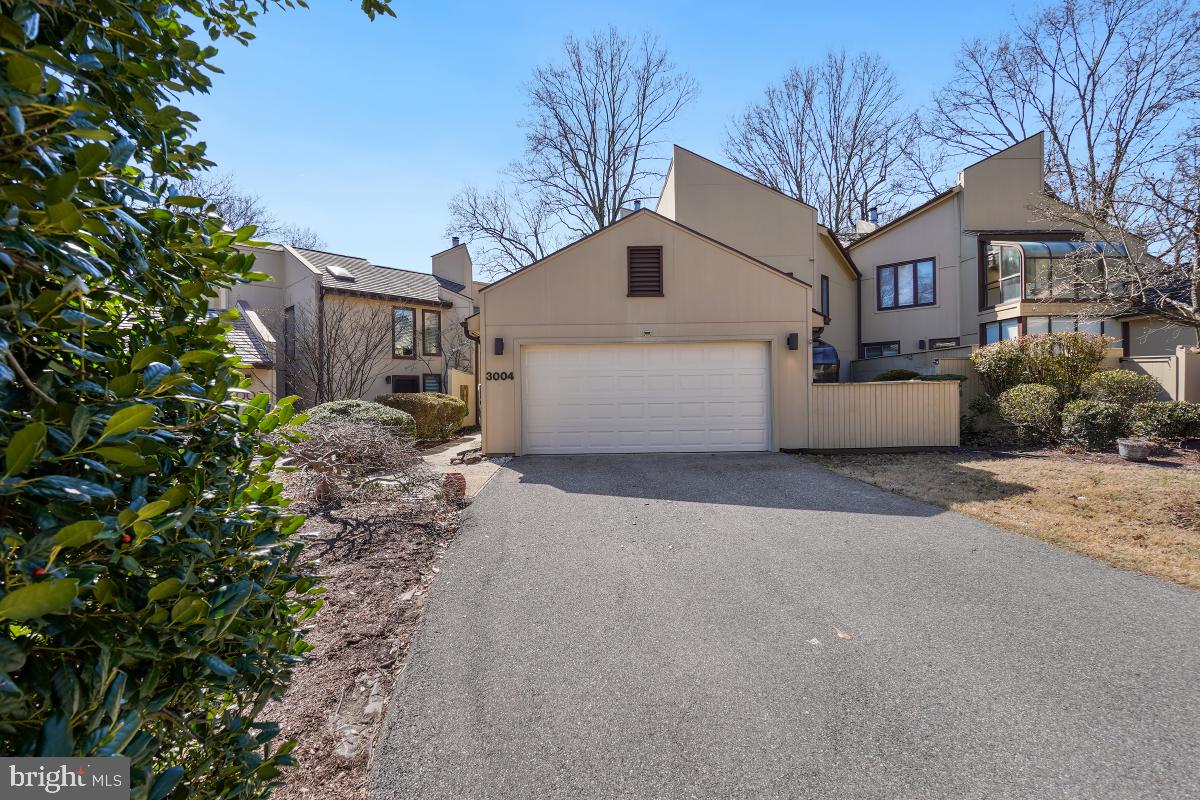 a view of a white house with a yard and garage
