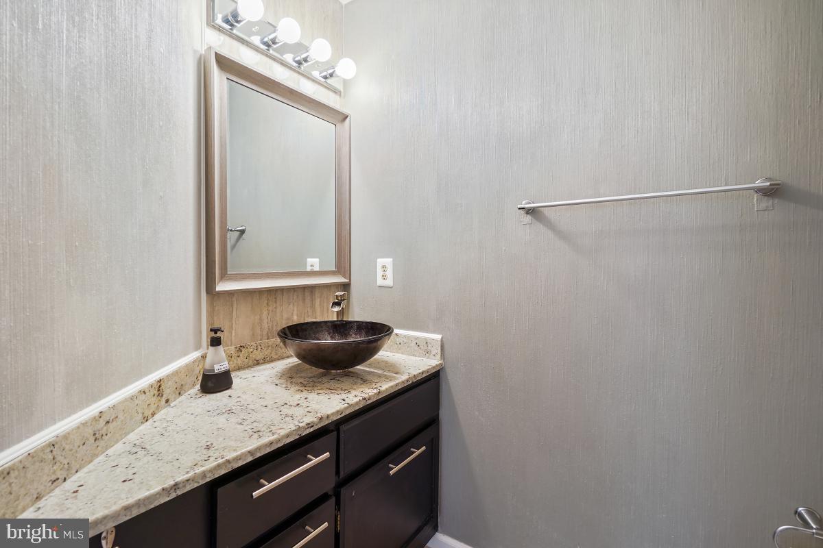 3004 Courtside Road Bowie, MD 20721 - Photo 20 of 45 a bathroom with a granite countertop sink and a mirror