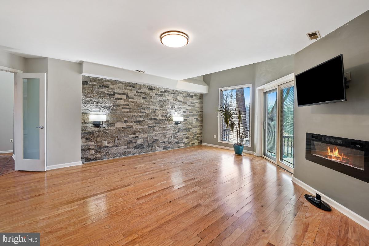 3004 Courtside Road Bowie, MD 20721 - Photo 23 of 45 a view of a livingroom with wooden floor and a fireplace