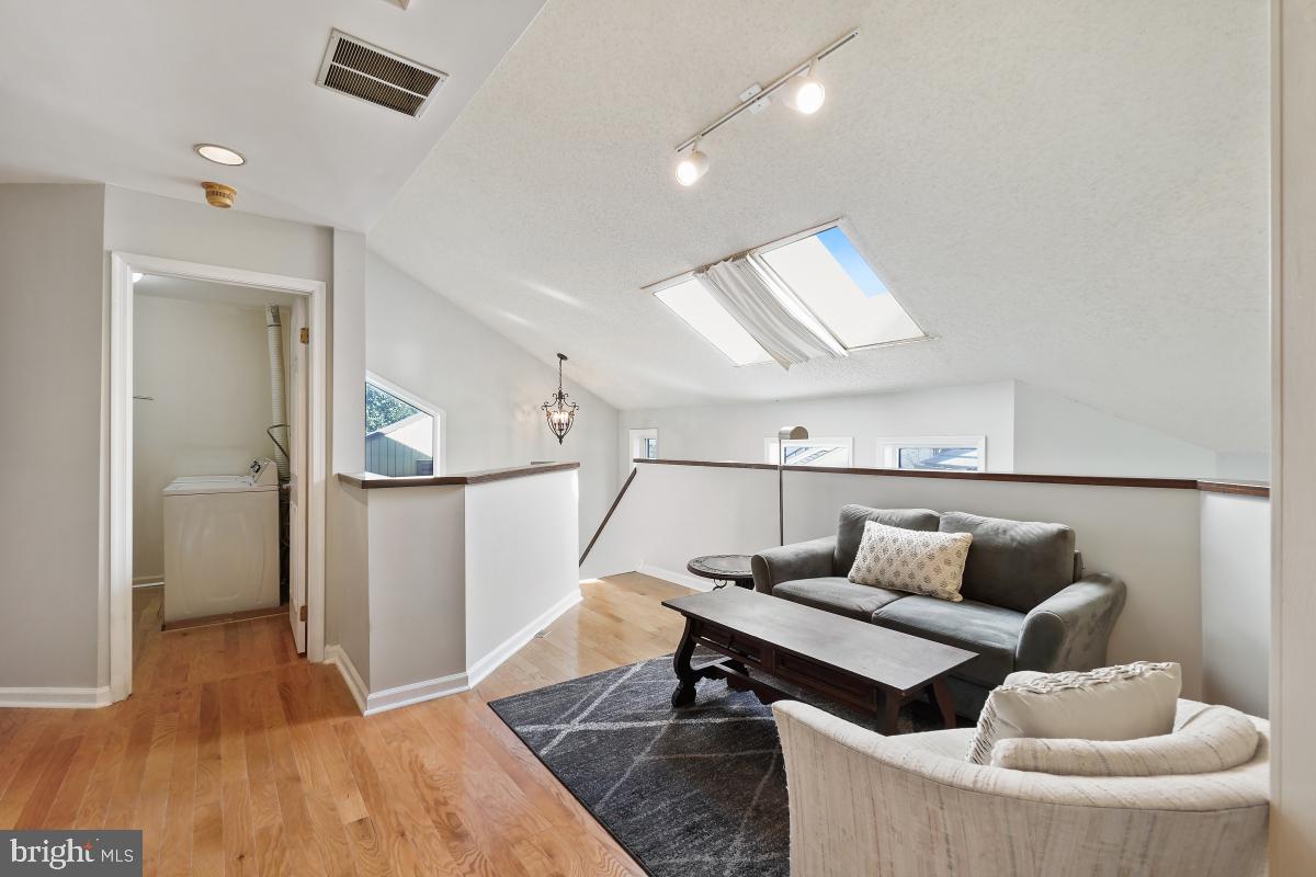 3004 Courtside Road Bowie, MD 20721 - Photo 29 of 45 a living room with furniture and a wooden floor
