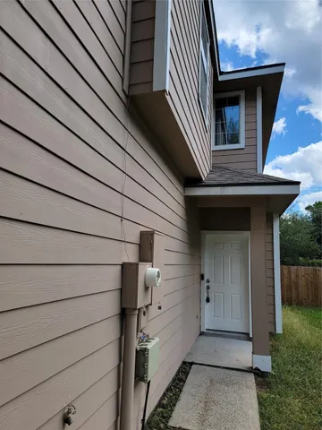 a view of a house with backyard and shower