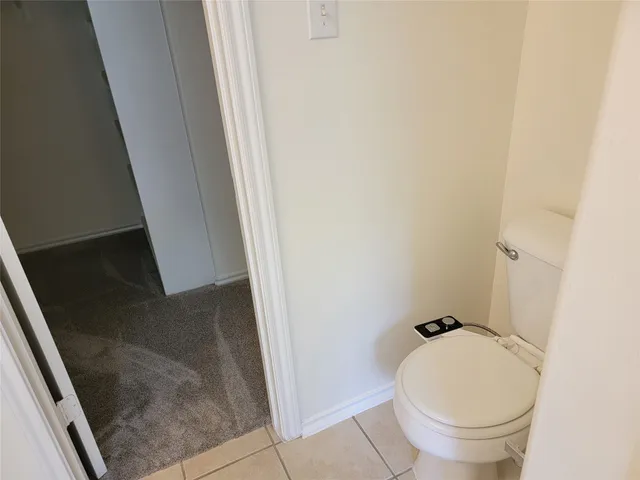 a bathroom with a granite countertop toilet and a sink