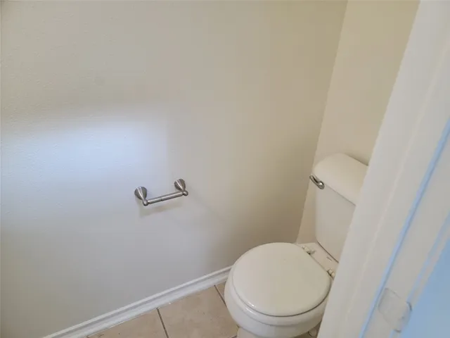 a white toilet sitting next to a shower