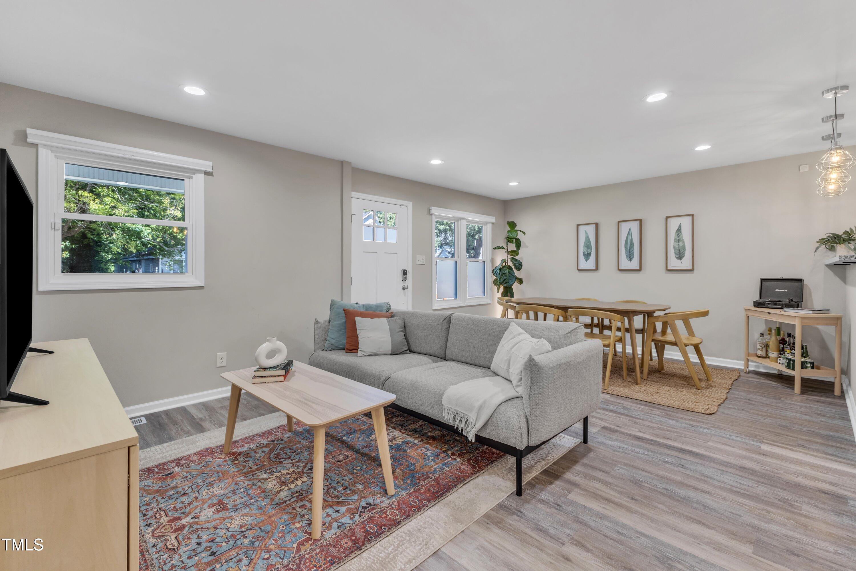 701 Coleman Street Raleigh, NC 27610 - Photo 8 of 38 a living room with furniture and wooden floor