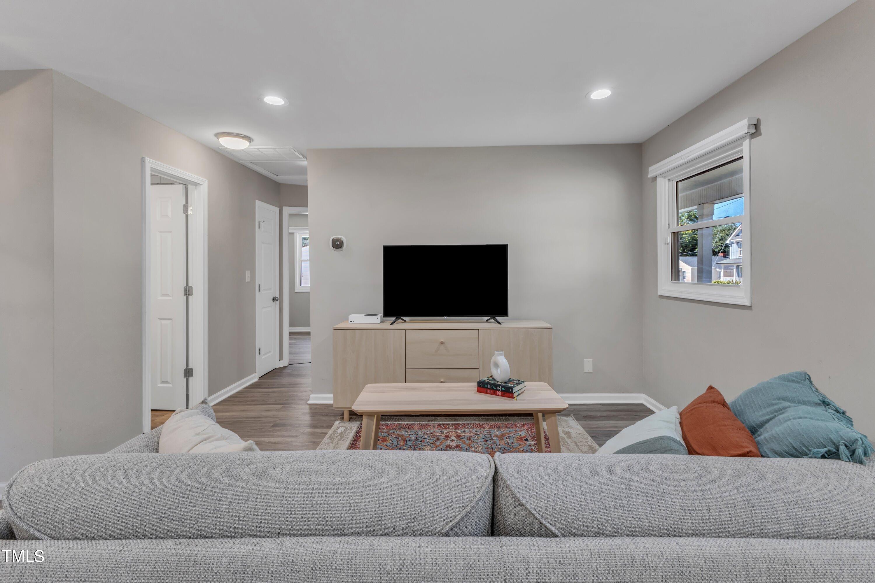 701 Coleman Street Raleigh, NC 27610 - Photo 9 of 38 a living room with furniture and a flat screen tv