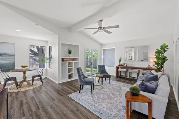 a living room with furniture and a wooden floor