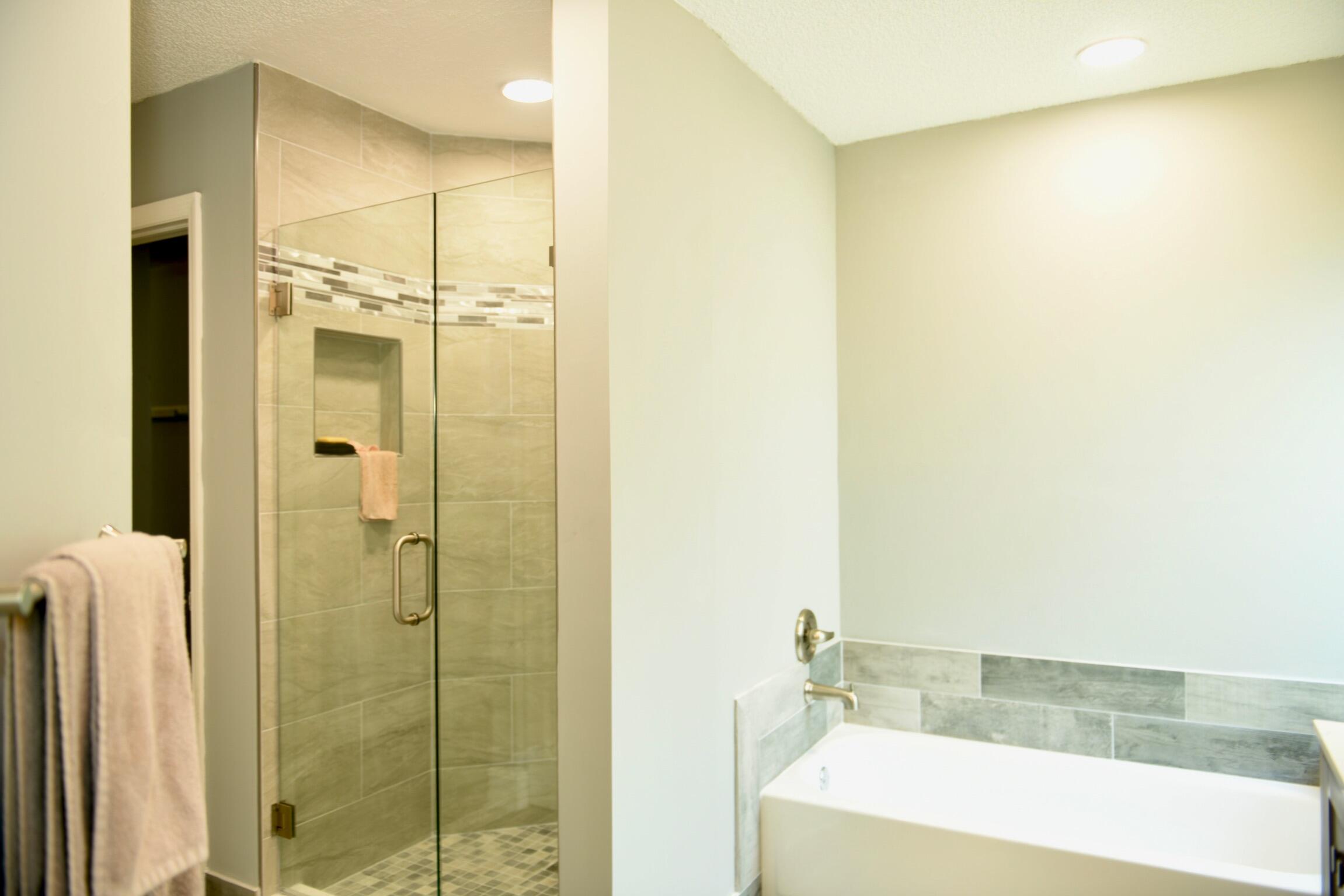 14931 Southwest 168th Court Miami, FL 33187 - Photo 11 of 34 a bathroom with a bathtub and a shower