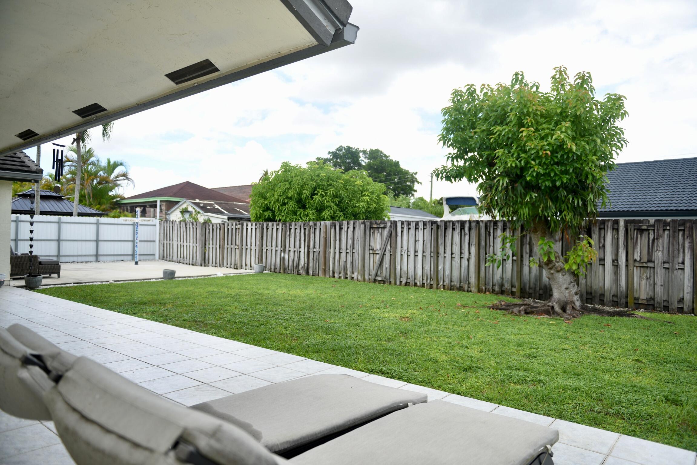 14931 Southwest 168th Court Miami, FL 33187 - Photo 16 of 34 a view of a backyard with wooden fence