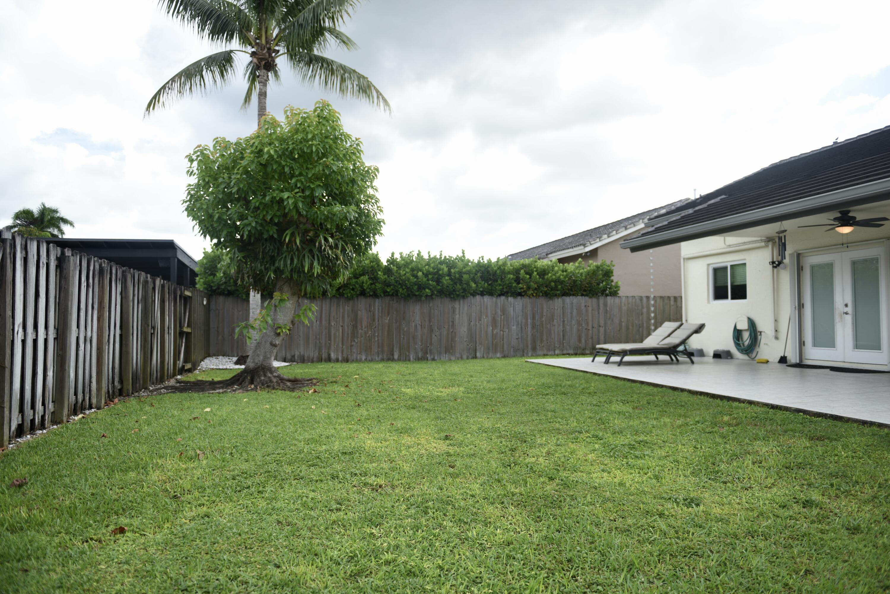 14931 Southwest 168th Court Miami, FL 33187 - Photo 19 of 34 a view of a backyard with a sitting area and slide
