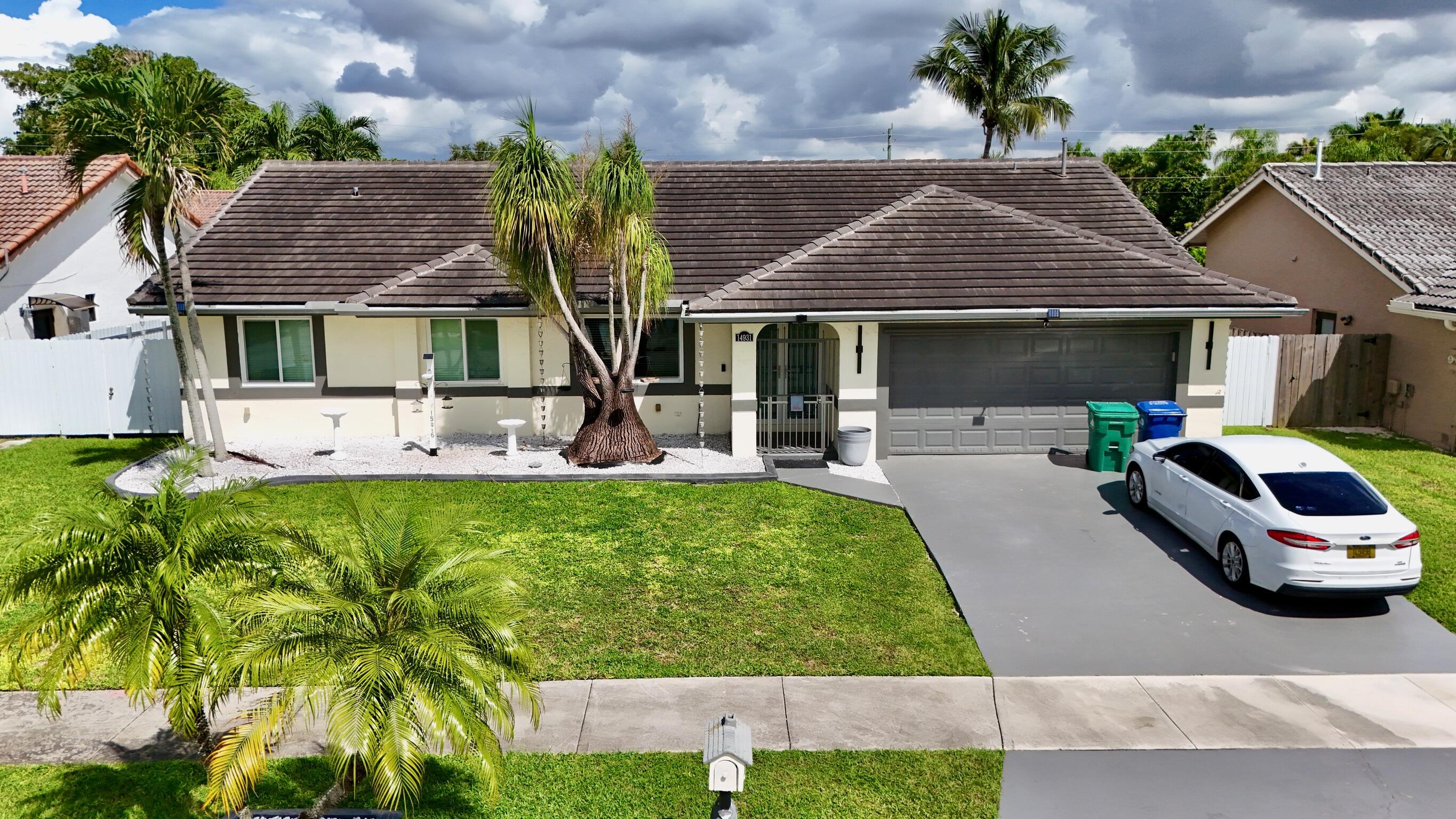 14931 Southwest 168th Court Miami, FL 33187 - Photo 25 of 34 front view of a house with a yard