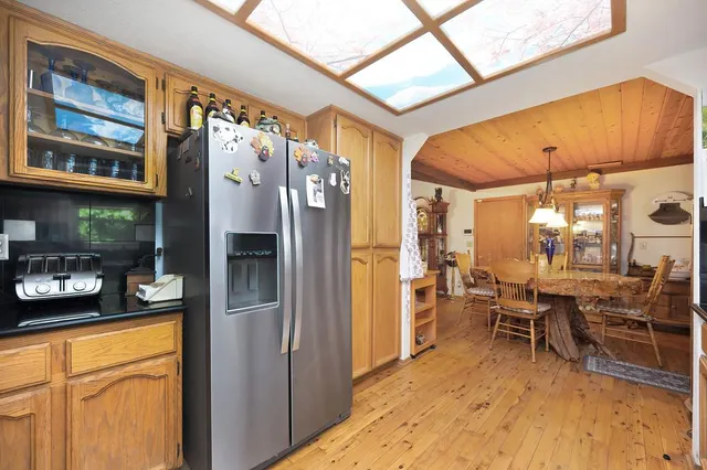 a kitchen with stainless steel appliances granite countertop a refrigerator and a stove top oven