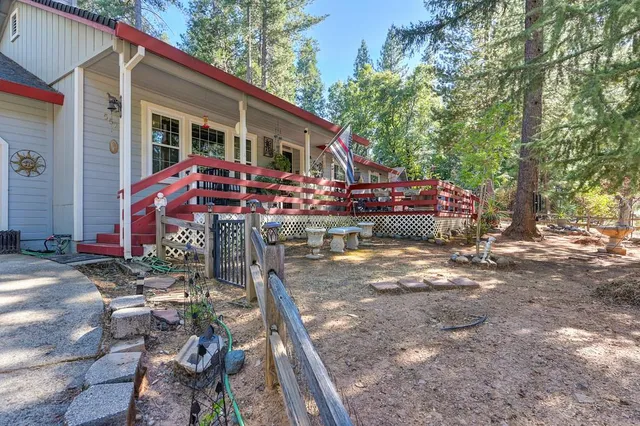 a patio with wooden table and chairs