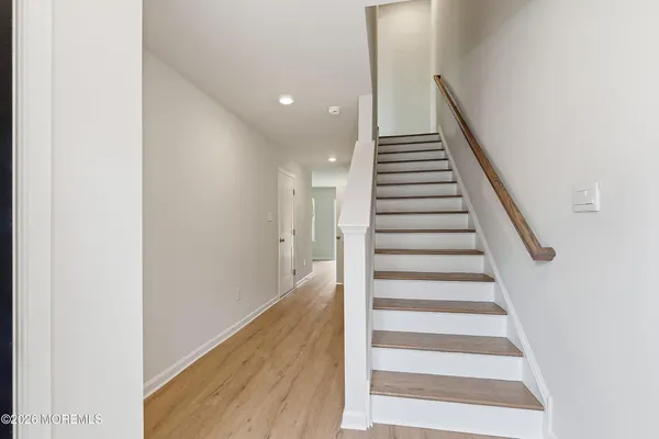 a view of entryway and hall with wooden floor