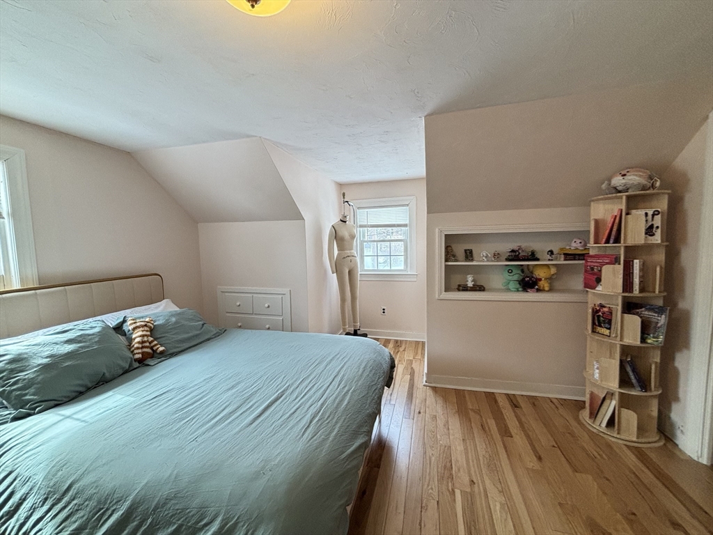 82 Prospect Street Gardner, MA 01440 - Photo 28 of 41 a bedroom with a bed and wooden floor