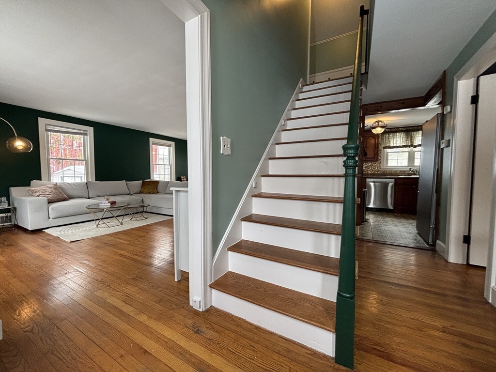 82 Prospect Street Gardner, MA 01440 - Photo 6 of 41 a view of a living room with wooden floor and stairs