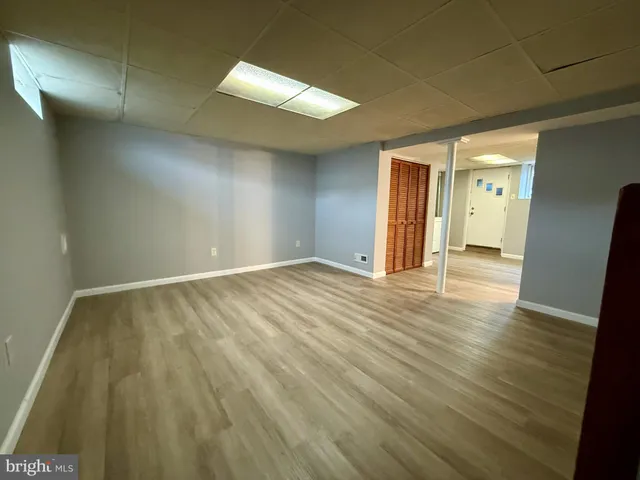 an empty room with wooden floor and sliding door