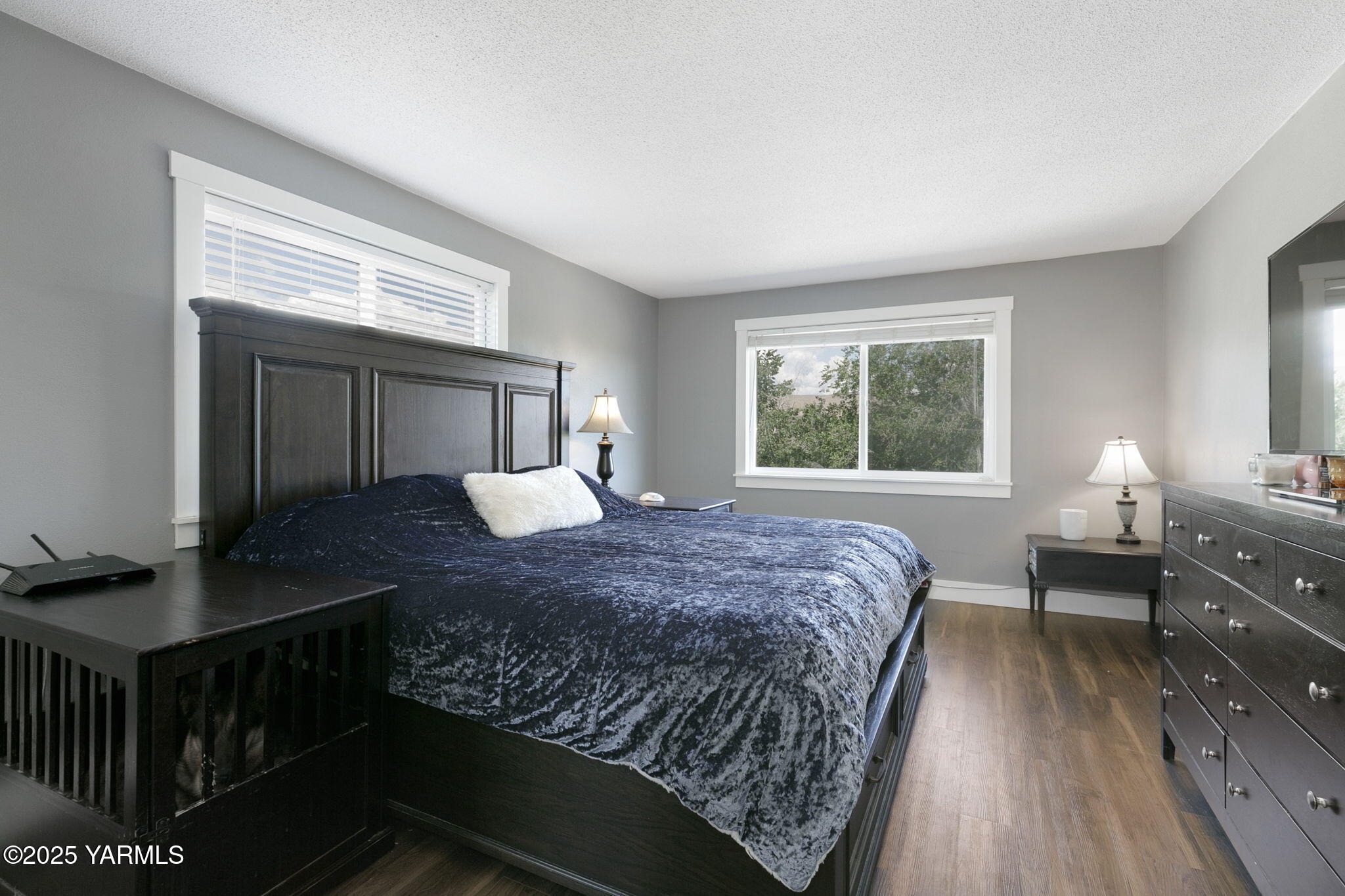 910 Gromore Road Yakima, WA 98908 - Photo 11 of 32 a bedroom with a bed and wooden floor