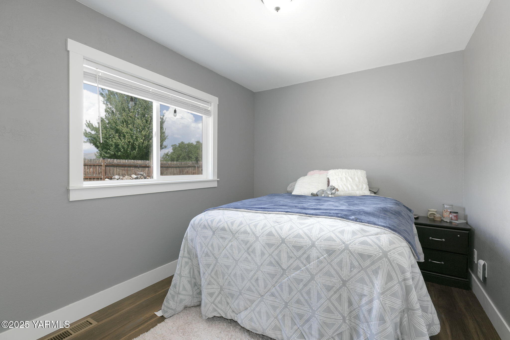 910 Gromore Road Yakima, WA 98908 - Photo 15 of 32 a bedroom with a bed and a window
