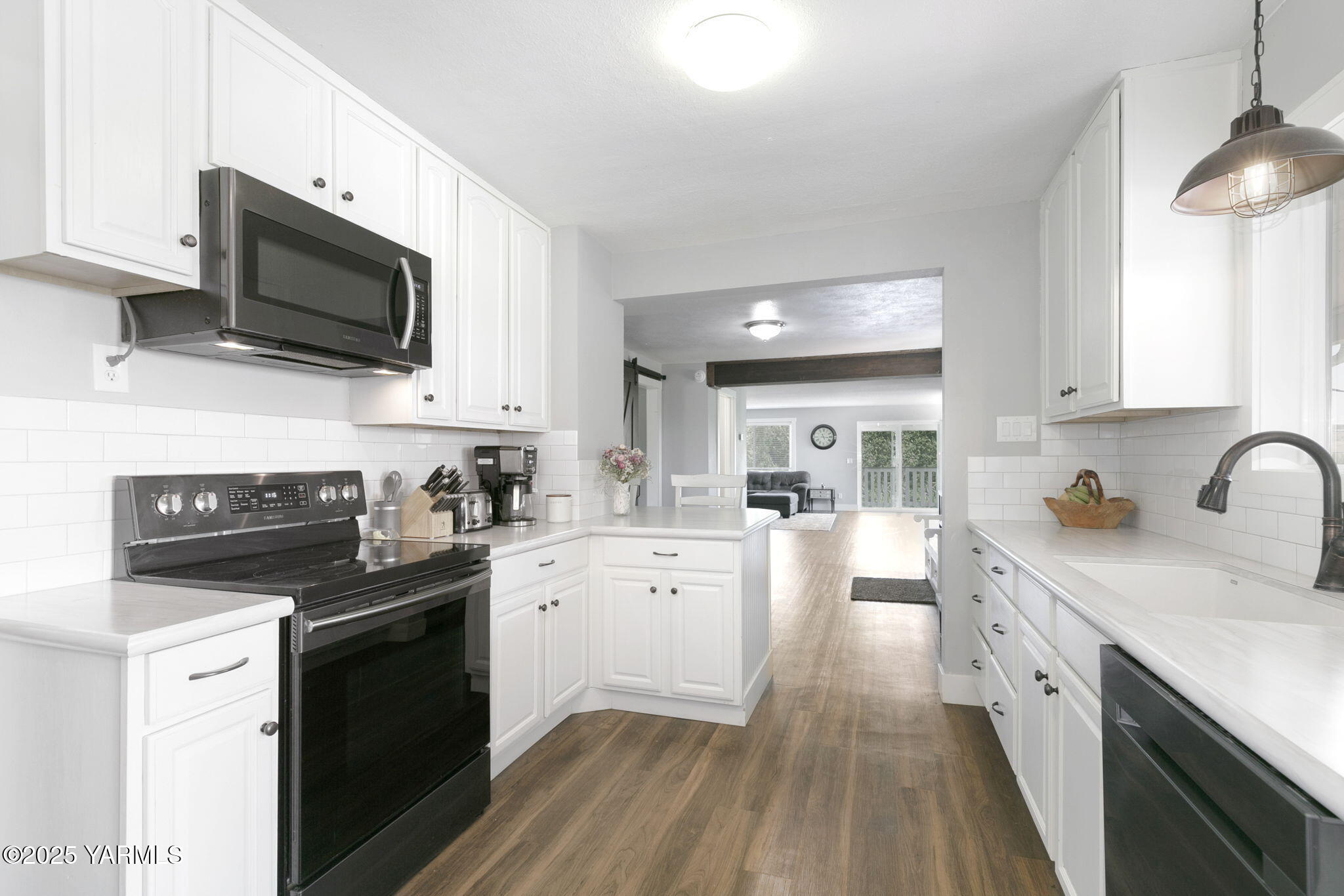910 Gromore Road Yakima, WA 98908 - Photo 6 of 32 a kitchen with stainless steel appliances a stove sink microwave and cabinets