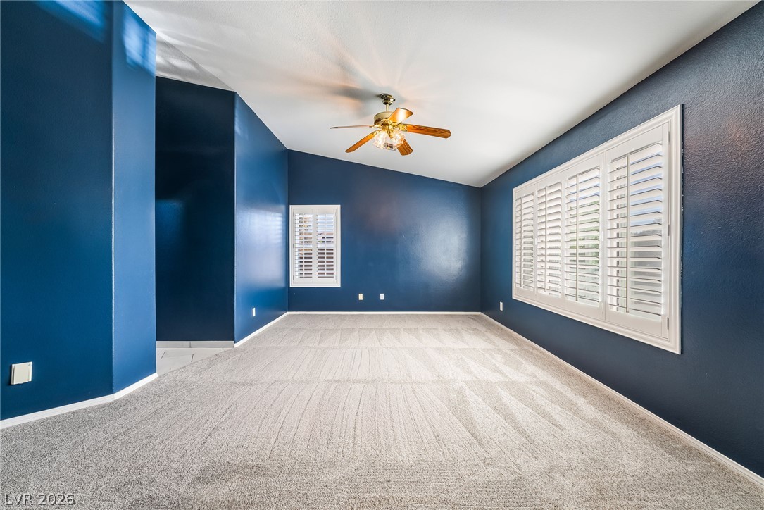 261 Timber Hollow Street Henderson, NV 89012 - Photo 32 of 51 Lofty ceilings and plantation shutters grace this spacious room, creating an airy and private retreat.