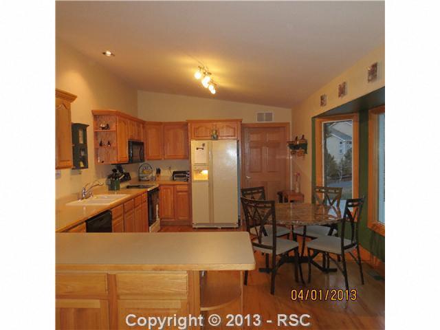 15351 Ridgefield Lane Colorado Springs, CO 80921 - Photo 5 of 15 Kitchen with eating nook, hardwood floors and bay window