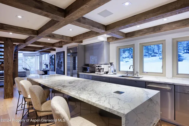 a dining table with chairs and window