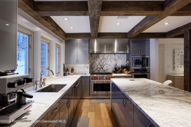 a kitchen with a stove a sink and a refrigerator