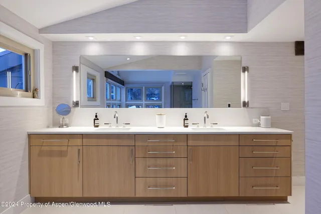 a bathroom with a sink double vanity and mirror