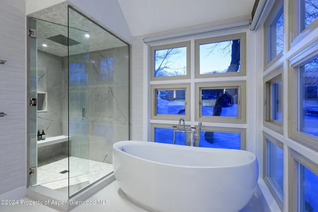 a white bath tub sitting next to a bathroom