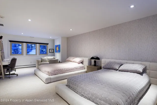 a bedroom with two beds and painted walls