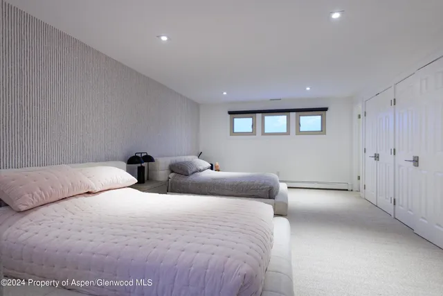 a bedroom with two beds and a window