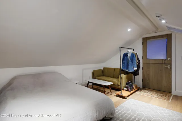 a bedroom with a bed a desk and chair