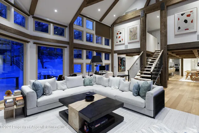a living room with furniture ceiling fan and a rug
