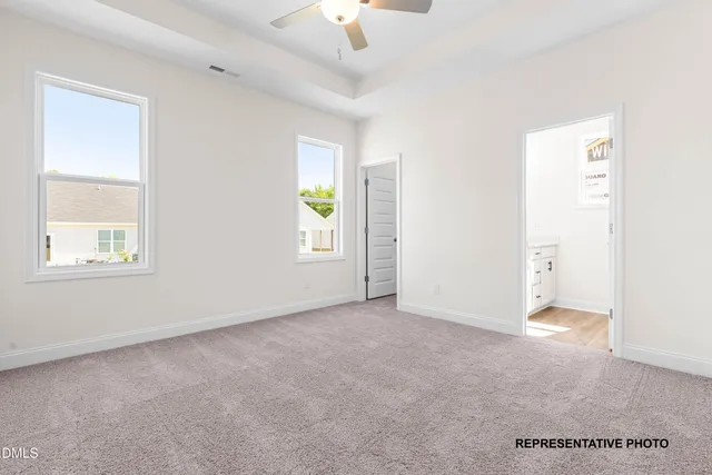 an empty room with windows and cabinet