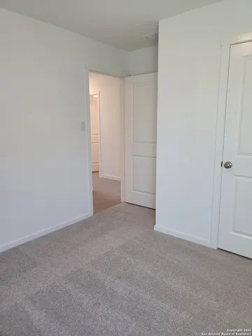 a view of an empty room and closet area