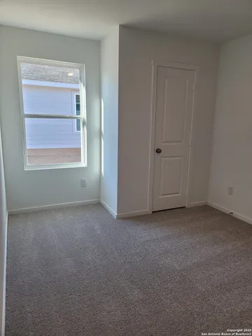 a view of a large white house with a yard and balcony