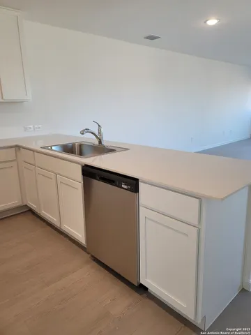a kitchen with a sink and cabinets