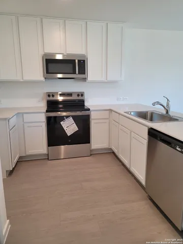 a kitchen with granite countertop a sink and a stove