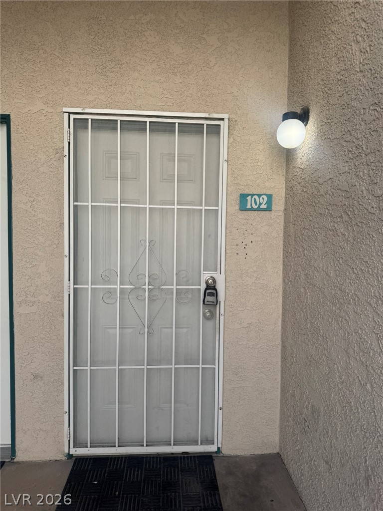 5141 South Lindell Road, Unit 102 Las Vegas, NV 89118 - Photo 3 of 17 Secure entry via a robust security gate and well-lit exterior for peace of mind.