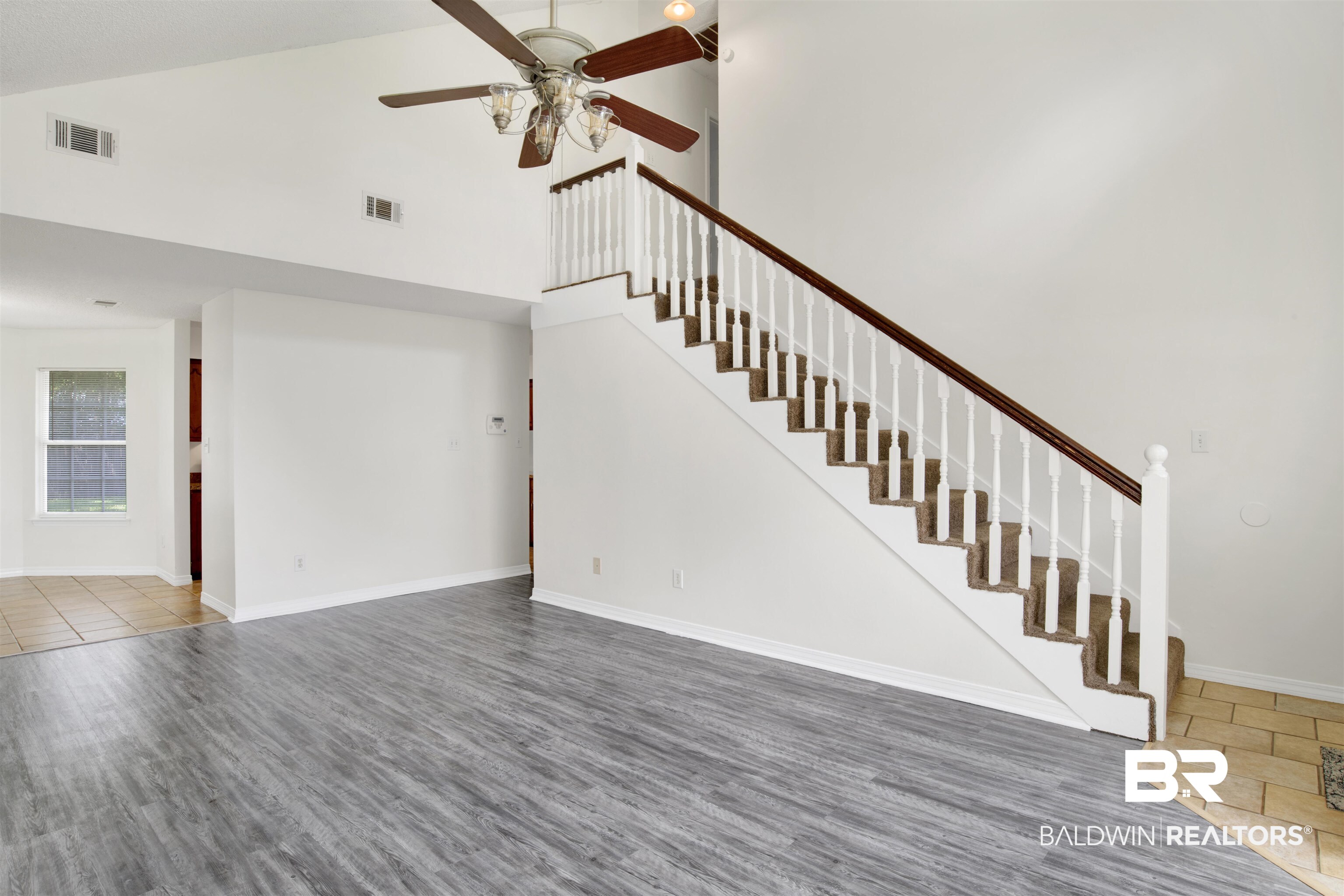 5480 Country Club Boulevard Theodore, AL 36582 - Photo 9 of 36 Unfurnished living room with wood-type flooring, ceiling fan, and high vaulted ceiling