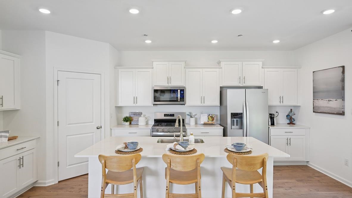 506 Scotty, Unit 1204 Rio Grande, NJ 08242 - Photo 20 of 44 a kitchen with stainless steel appliances kitchen island granite countertop a dining table and chairs