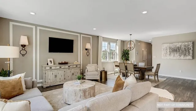 a kitchen with stainless steel appliances a refrigerator and a chandelier