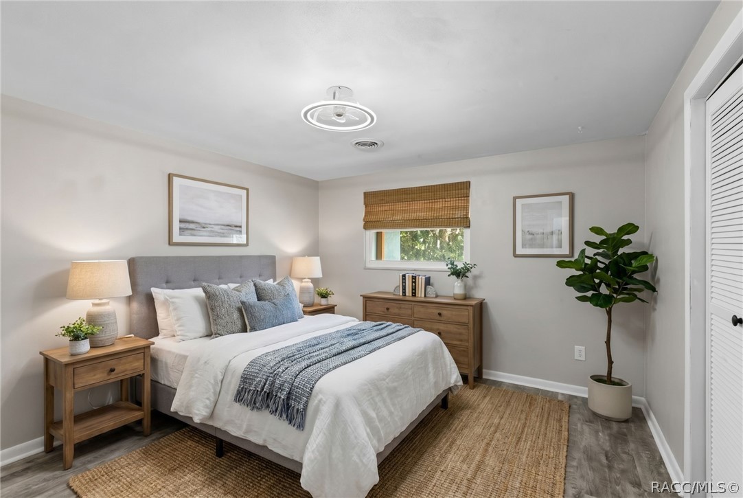 107 Allen Avenue Inglis, FL 34449 - Photo 11 of 36 a bedroom with a bed and a potted plant