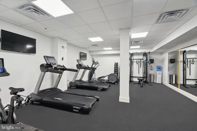 a kitchen with a table chairs and wooden floor