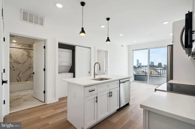 a kitchen with a sink and refrigerator